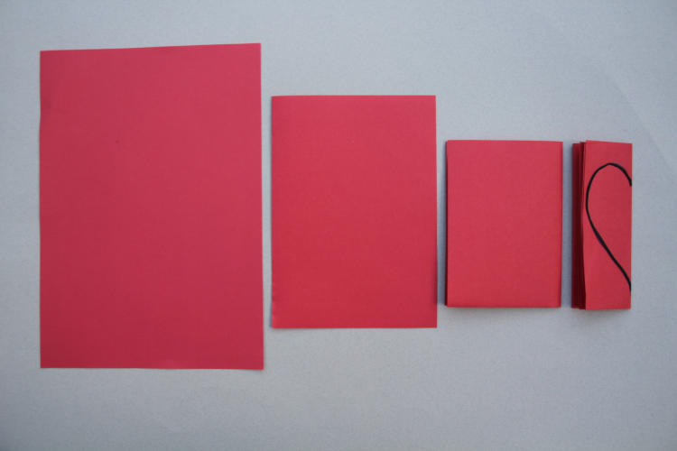 paper folded in quarters with heart shape for 4 times tables activity