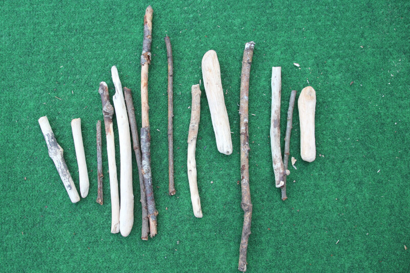 outdoor maths sticks lined up to count for division by four activity