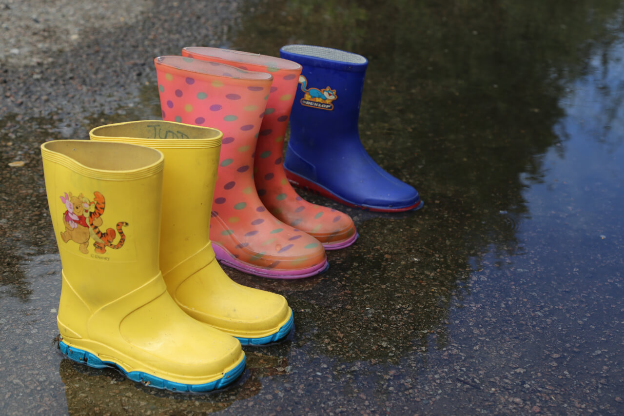 five wellington boots, two pairs and one odd boot
